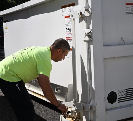 Workhorse Hauling | Person unlocking roll-off dumpster | Ohio | Dumpster Services